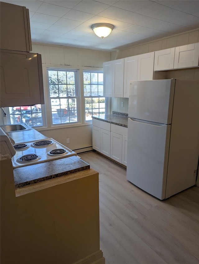 118 Mac Farlane Rd, Wappingers Falls, NY 12590 - kitchen featuring freestanding refrigerator, white cabinetry, a baseboard heating unit, light wood finished floors, and a sink