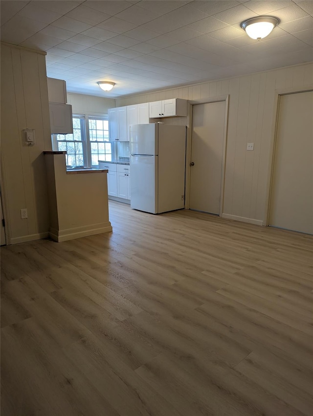 118 Mac Farlane Rd, Wappingers Falls, NY 12590 - kitchen featuring freestanding refrigerator, light wood-style flooring, white cabinets, and baseboards