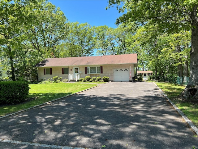 662 Gillette Ave, Bayport, NY 11705 - view of front of house featuring an attached garage and asphalt driveway