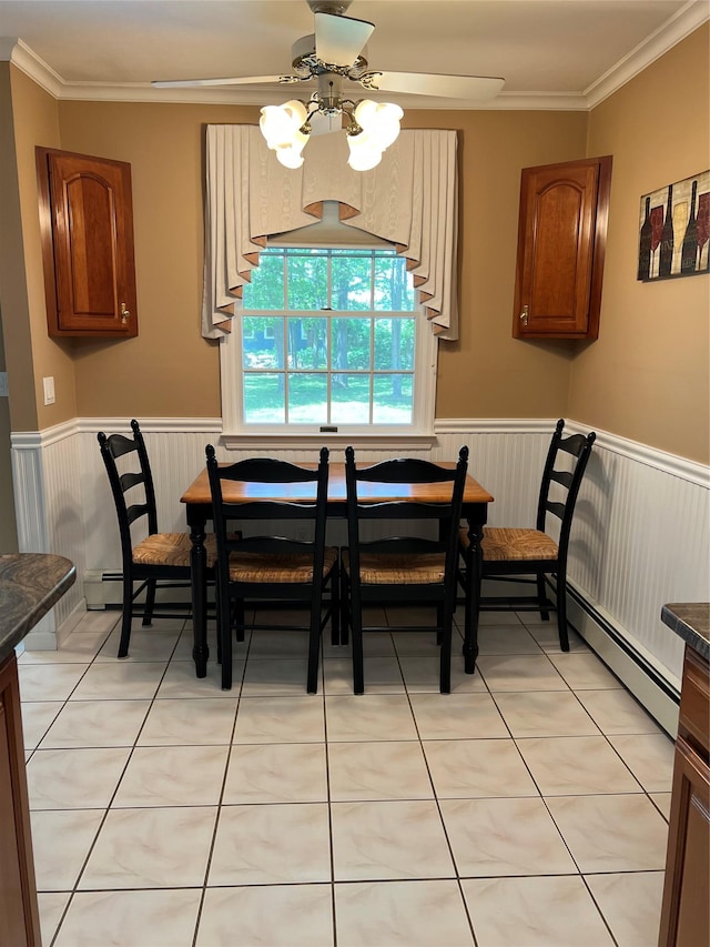 662 Gillette Ave, Bayport, NY 11705 - dining area with a wainscoted wall, ornamental molding, a ceiling fan, and light tile patterned floors