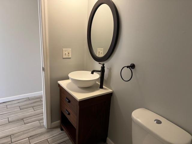 350 N Water St Unit 1-7, Newburgh, NY 12550 - half bath featuring vanity, wood finish floors, baseboards, and toilet