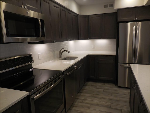 350 N Water St Unit 1-7, Newburgh, NY 12550 - kitchen featuring appliances with stainless steel finishes, a sink, tasteful backsplash, wood finished floors, and light stone counters