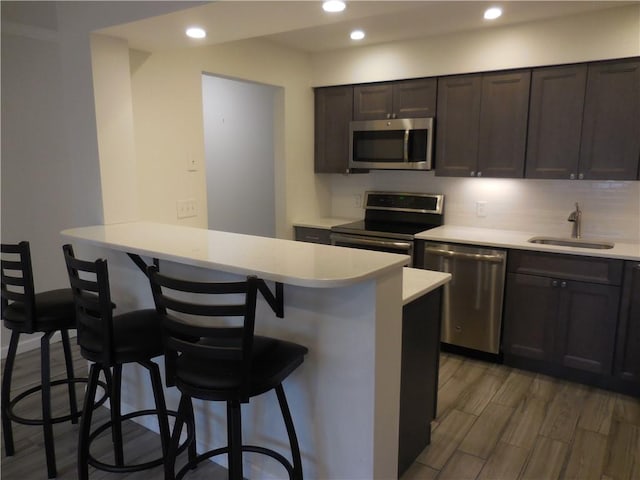 350 N Water St Unit 1-7, Newburgh, NY 12550 - kitchen with stainless steel appliances, a breakfast bar, light countertops, a sink, and recessed lighting