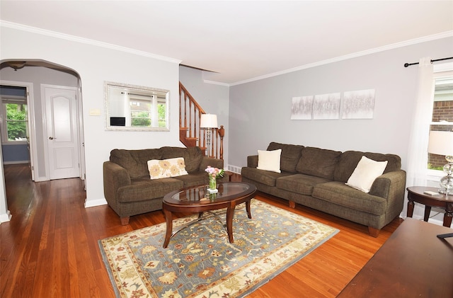 145 Gerard Ave, New Hyde Park, NY 11040 - living room featuring crown molding, stairway, wood finished floors, plenty of natural light, and arched walkways