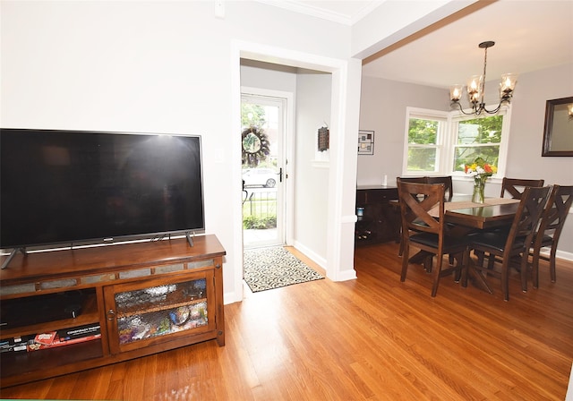 145 Gerard Ave, New Hyde Park, NY 11040 - dining area featuring a chandelier, wood finished floors, crown molding, and healthy amount of natural light