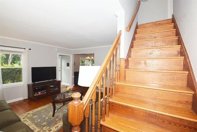 145 Gerard Ave, New Hyde Park, NY 11040 - stairs with wood finished floors, a chandelier, and crown molding