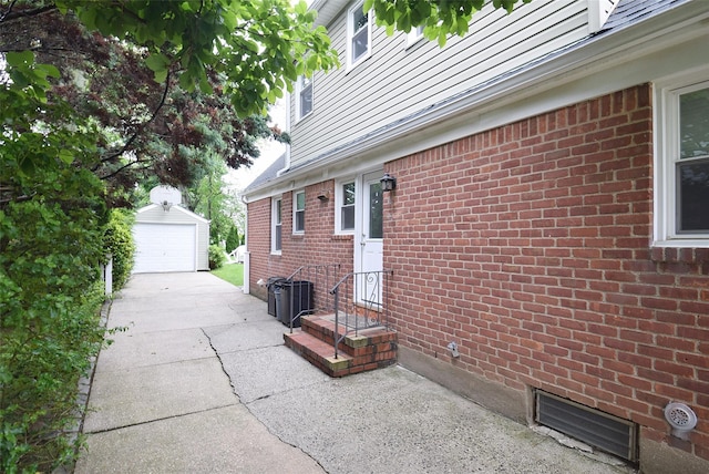 145 Gerard Ave, New Hyde Park, NY 11040 - view of patio / terrace featuring a garage and an outbuilding