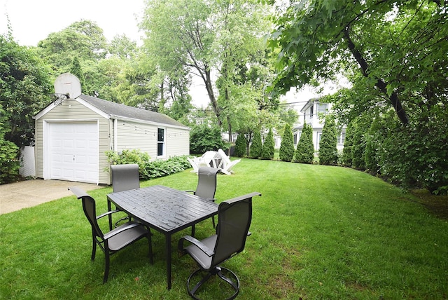 145 Gerard Ave, New Hyde Park, NY 11040 - view of grassy yard with an outdoor structure, a garage, outdoor dining space, and driveway