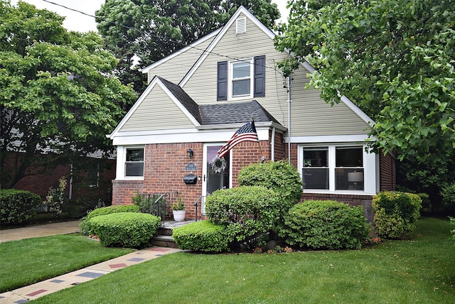 145 Gerard Ave, New Hyde Park, NY 11040 - view of front of property featuring brick siding, a front yard, and roof with shingles