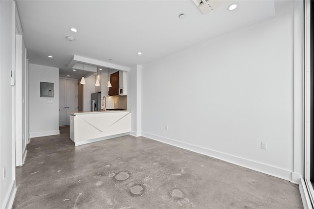 20 Melrose St Unit 4F, Brooklyn, NY 11206 - unfurnished living room featuring concrete floors, baseboards, recessed lighting, and a sink