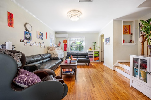 20-29 150th St, Whitestone, NY 11357 - living area with a wall mounted air conditioner, arched walkways, light wood finished floors, crown molding, and baseboards