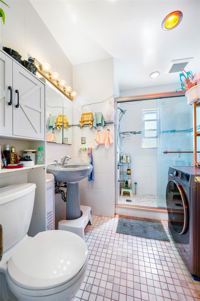 20-29 150th St, Whitestone, NY 11357 - bathroom featuring washer / clothes dryer, toilet, a shower stall, a sink, and tile walls