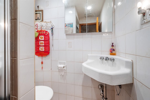 20-29 150th St, Whitestone, NY 11357 - bathroom featuring tile walls, toilet, and a sink