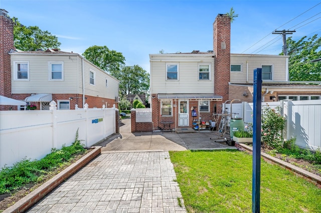 20-29 150th St, Whitestone, NY 11357 - back of house with a patio area, brick siding, and a chimney