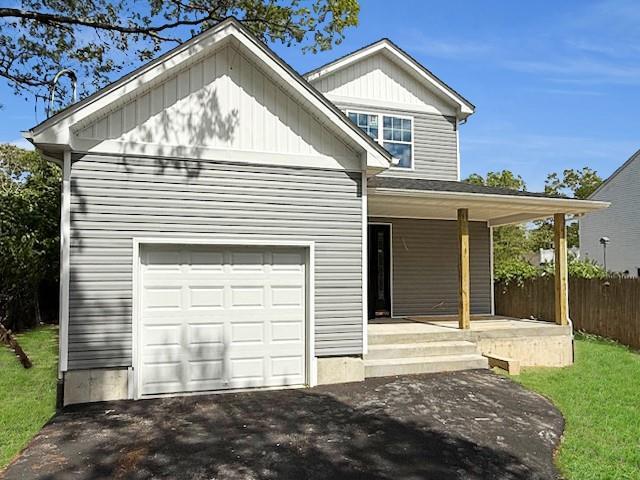 114 W End Dr, Shirley, NY 11967 - view of front of property featuring a porch, a garage, and driveway
