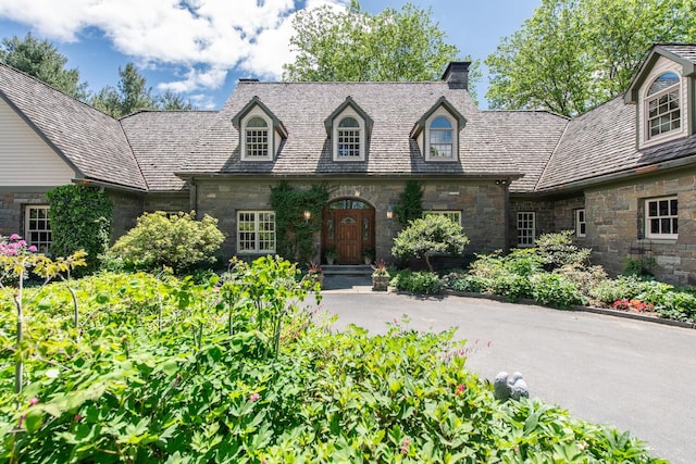 189 Freedom Rd, Pleasant Valley, NY 12569 - view of front facade with stone siding, a chimney, and a high end roof