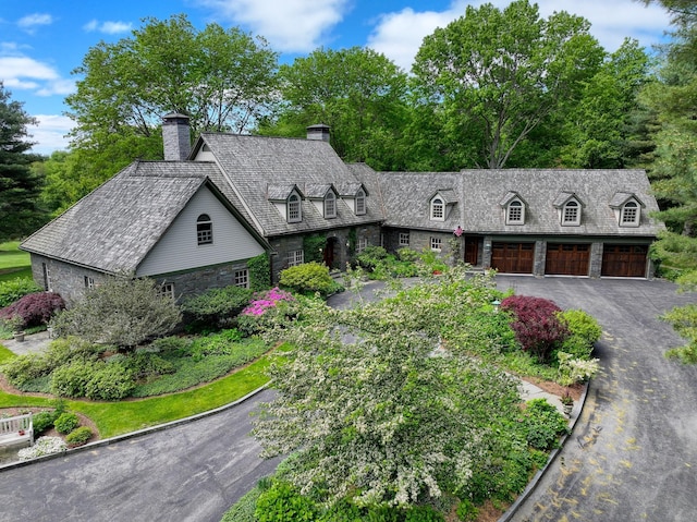 189 Freedom Rd, Pleasant Valley, NY 12569 - new england style home with stone siding, a chimney, a garage, and driveway