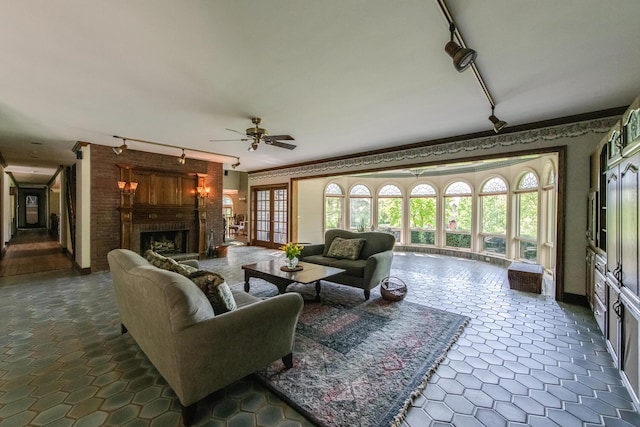 189 Freedom Rd, Pleasant Valley, NY 12569 - living area with track lighting, a brick fireplace, a ceiling fan, healthy amount of natural light, and ornamental molding