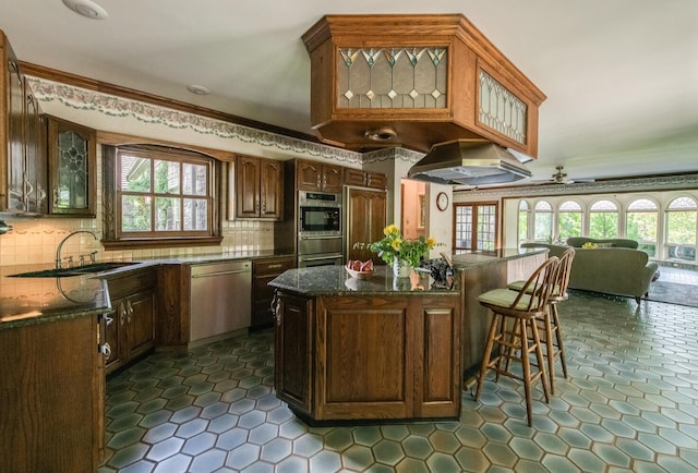 189 Freedom Rd, Pleasant Valley, NY 12569 - kitchen featuring stainless steel appliances, island range hood, a sink, glass insert cabinets, and crown molding