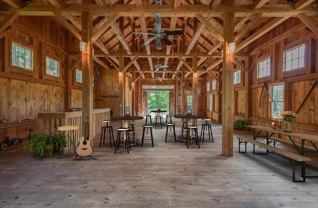 189 Freedom Rd, Pleasant Valley, NY 12569 - miscellaneous room with a high ceiling, wood walls, wood-type flooring, and a ceiling fan