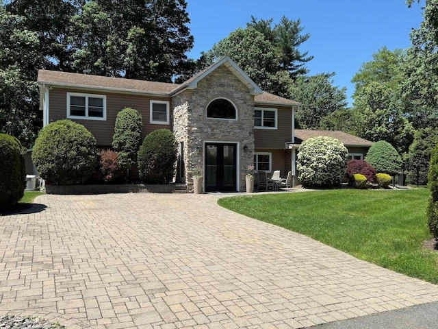 15 Spruce Ct, Nanuet, NY 10954 - view of front of home featuring french doors, a front lawn, stone siding, and driveway