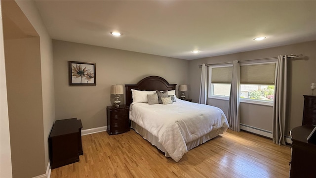 15 Spruce Ct, Nanuet, NY 10954 - bedroom with a baseboard heating unit, light wood finished floors, baseboards, and recessed lighting