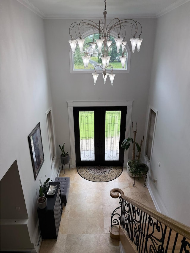 15 Spruce Ct, Nanuet, NY 10954 - entryway featuring plenty of natural light, french doors, a chandelier, a high ceiling, and ornamental molding