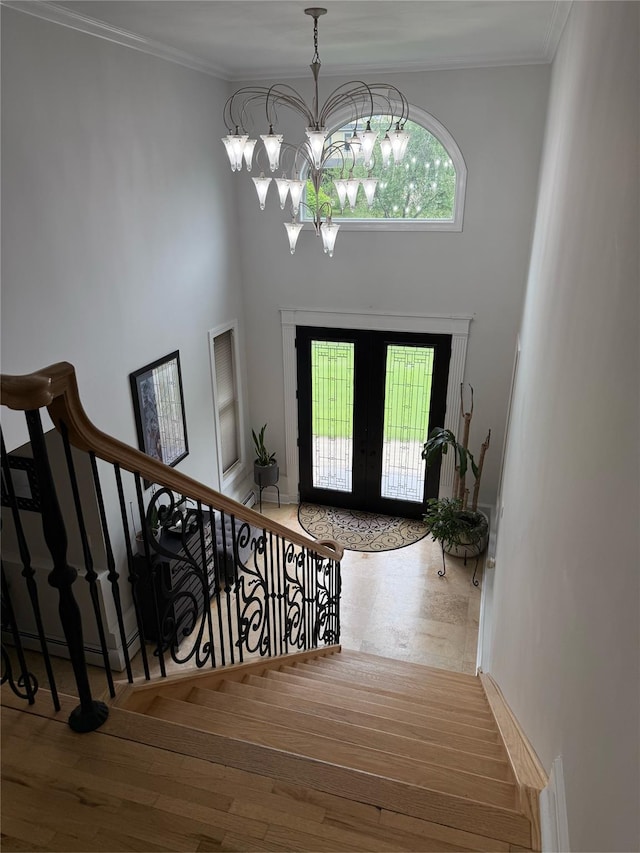 15 Spruce Ct, Nanuet, NY 10954 - foyer entrance featuring french doors, stairs, a chandelier, wood finished floors, and crown molding