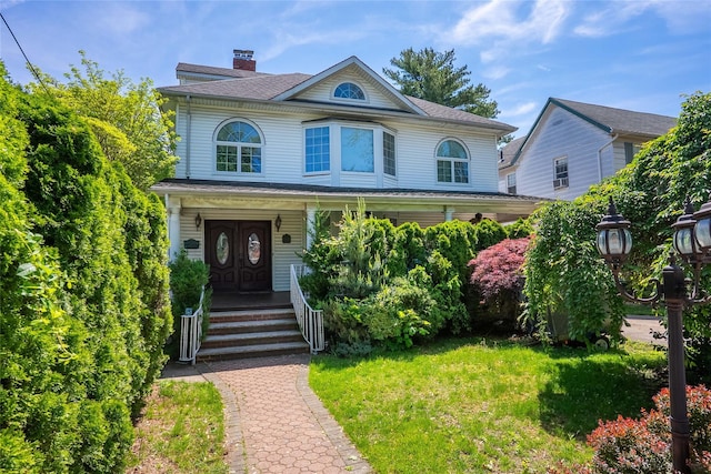 3225 155th St, Flushing, NY 11354 - view of front of home with a porch, a chimney, and a front yard
