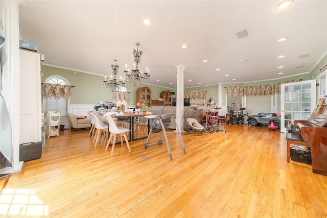 3225 155th St, Flushing, NY 11354 - dining area featuring crown molding, ornate columns, light wood-type flooring, recessed lighting, and a chandelier