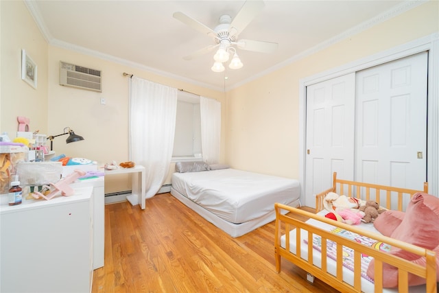 3225 155th St, Flushing, NY 11354 - bedroom featuring crown molding, light wood finished floors, a closet, an AC wall unit, and ceiling fan