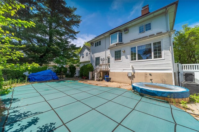 3225 155th St, Flushing, NY 11354 - rear view of property featuring a hot tub, a chimney, and a patio