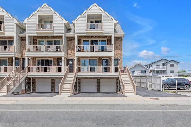 51 W Broadway Unit A, Long Beach, NY 11561 - view of front of home with stone siding, stairs, and an attached garage
