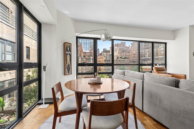 415 E 54th St Unit 10E, New York Manhattan, NY 10022 - dining space with a view of skyline and baseboards