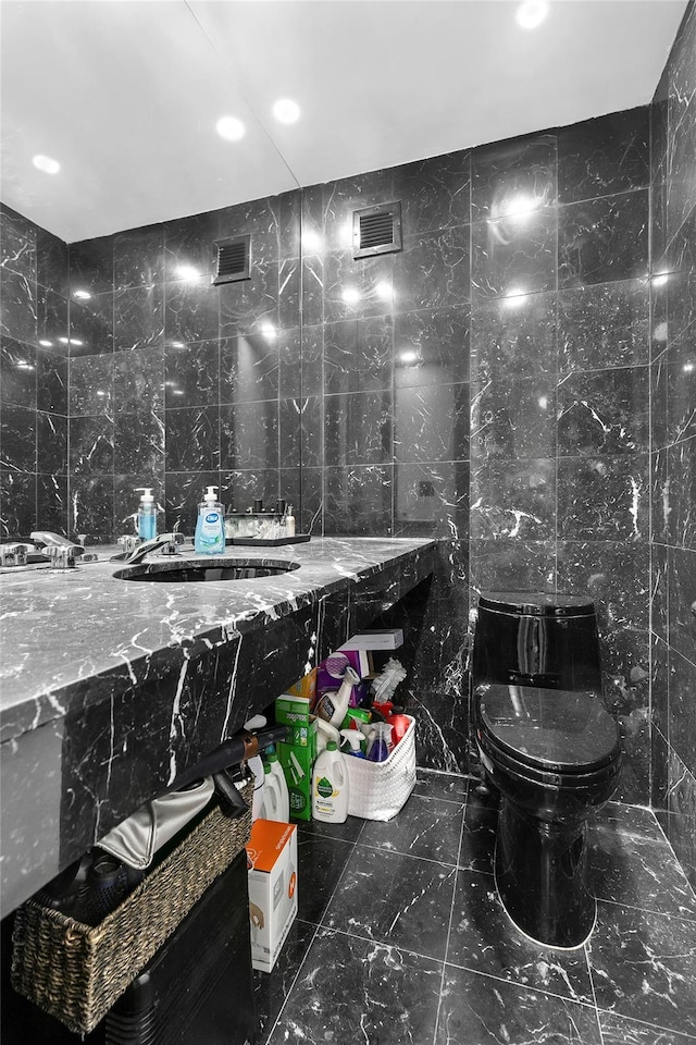 415 E 54th St Unit 10E, New York Manhattan, NY 10022 - bathroom featuring tile walls, a sink, and tasteful backsplash