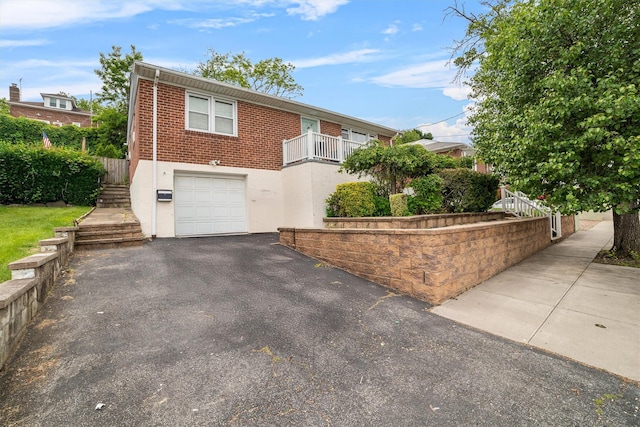 773 Mile Square Rd, Yonkers, NY 10704 - view of front of property featuring an attached garage, driveway, brick siding, and stairway