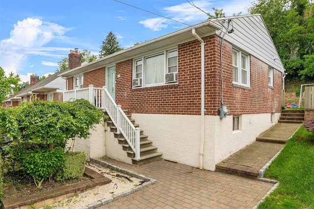 773 Mile Square Rd, Yonkers, NY 10704 - view of front of house featuring brick siding, stairs, a chimney, and cooling unit