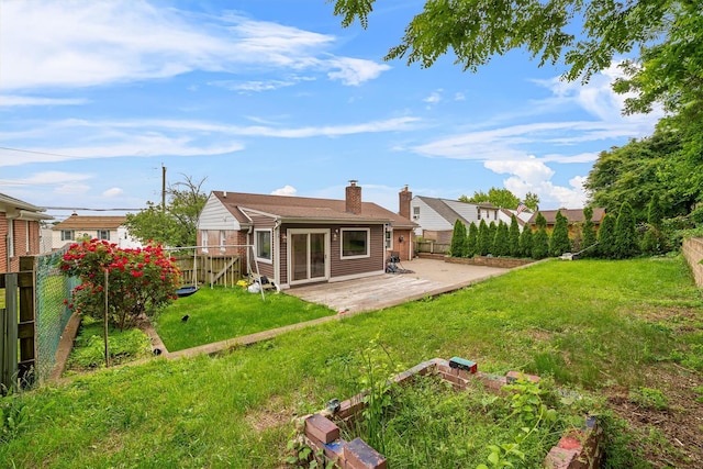773 Mile Square Rd, Yonkers, NY 10704 - rear view of house with a chimney and a patio
