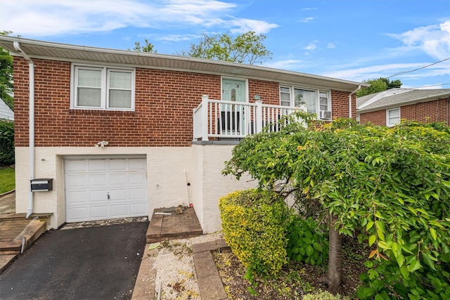 773 Mile Square Rd, Yonkers, NY 10704 - ranch-style home featuring an attached garage, asphalt driveway, brick siding, and stucco siding