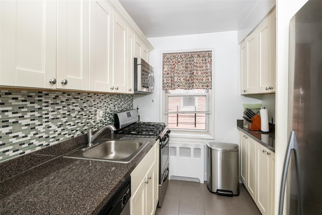 60 Locust Unit A-609, New Rochelle, NY 10801 - kitchen featuring appliances with stainless steel finishes, a sink, decorative backsplash, white cabinets, and tile patterned floors
