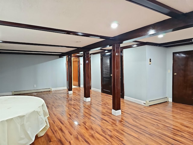 154-70 11th Ave, Whitestone, NY 11357 - finished basement featuring a baseboard radiator, light wood-type flooring, recessed lighting, and baseboards