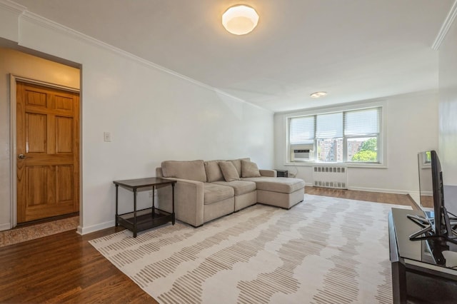 18-50 211th St Unit 2D, Bayside, NY 11360 - living room featuring radiator, crown molding, wood finished floors, and baseboards