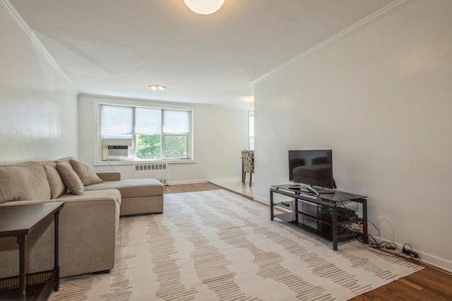 18-50 211th St Unit 2D, Bayside, NY 11360 - living area featuring radiator heating unit, ornamental molding, wood finished floors, and baseboards