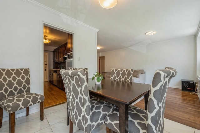 18-50 211th St Unit 2D, Bayside, NY 11360 - dining space with ornamental molding and light wood-style flooring