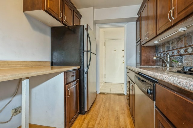 18-50 211th St Unit 2D, Bayside, NY 11360 - kitchen featuring appliances with stainless steel finishes, a sink, tasteful backsplash, and light wood-style flooring