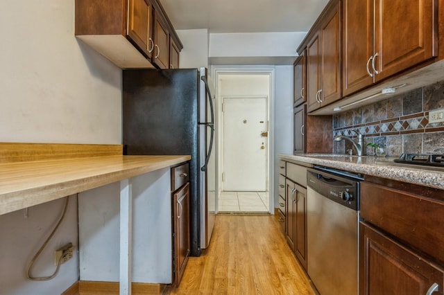 18-50 211th St Unit 2D, Bayside, NY 11360 - kitchen featuring stainless steel appliances, decorative backsplash, a sink, light wood finished floors, and butcher block counters