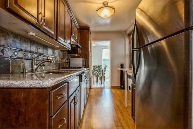 18-50 211th St Unit 2D, Bayside, NY 11360 - kitchen featuring freestanding refrigerator, a sink, tasteful backsplash, light wood-type flooring, and stone countertops