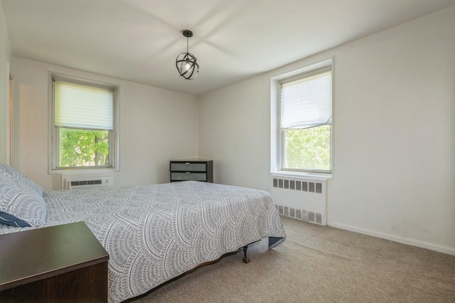 18-50 211th St Unit 2D, Bayside, NY 11360 - carpeted bedroom with radiator, a wall mounted air conditioner, and baseboards