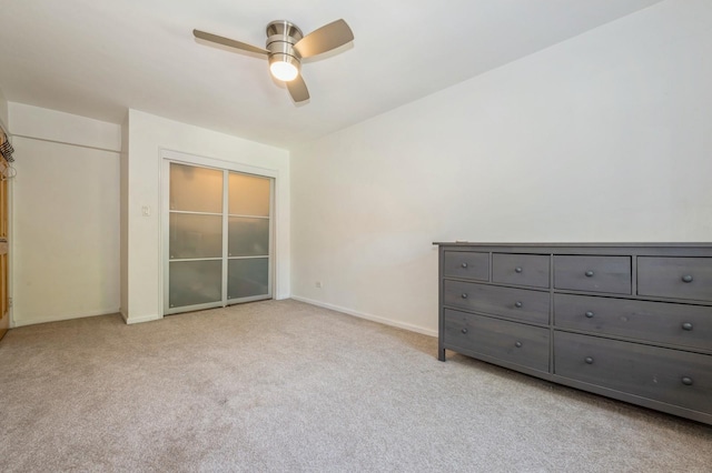 18-50 211th St Unit 2D, Bayside, NY 11360 - unfurnished bedroom with light colored carpet, baseboards, and a ceiling fan