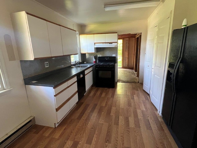 29 Purse Ln, Fishkill, NY 12533 - kitchen featuring black appliances, under cabinet range hood, a sink, a baseboard radiator, and dark countertops